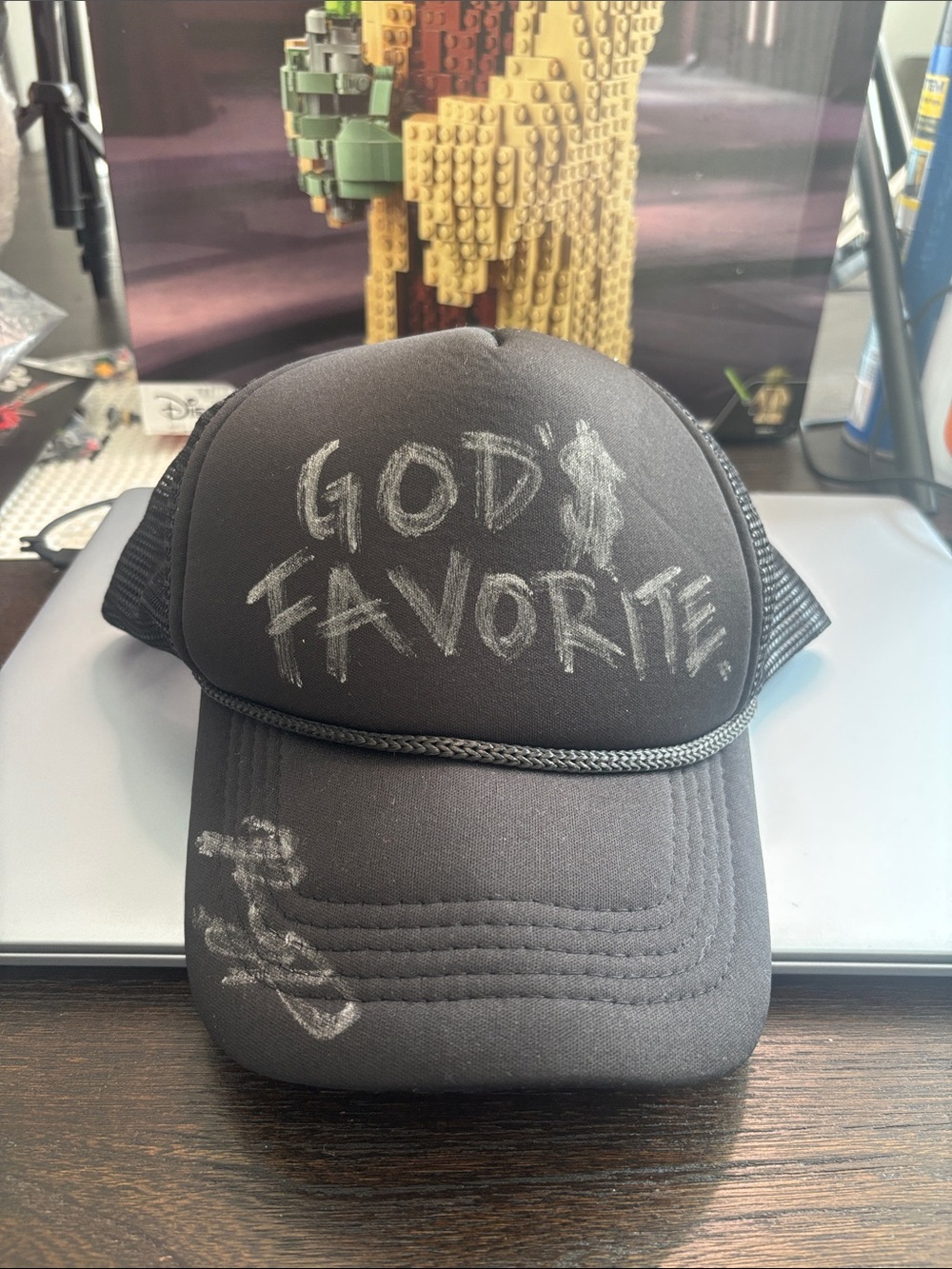 Black Trucker Hat with 'God's Favorite' Chalk-Style Graphic